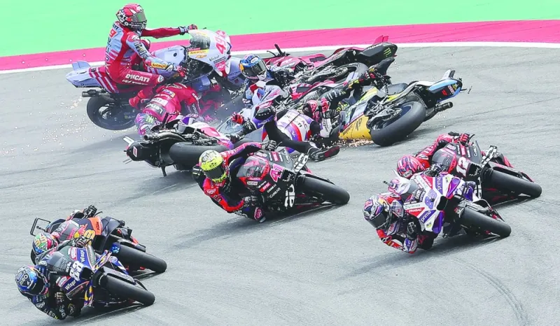 Riders fall during the MotoGP round of the Moto Grand Prix de Catalunya at the Circuit de Catalunya in Montmelo, on the outskirts of Barcelona, on Sunday. (AFP)