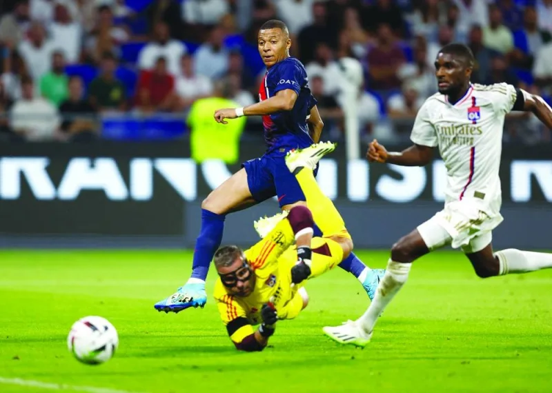 
Paris St Germain’s Kylian Mbappe (left) scores against Lyon during the Ligue 1 match on Sunday. (Reuters) 