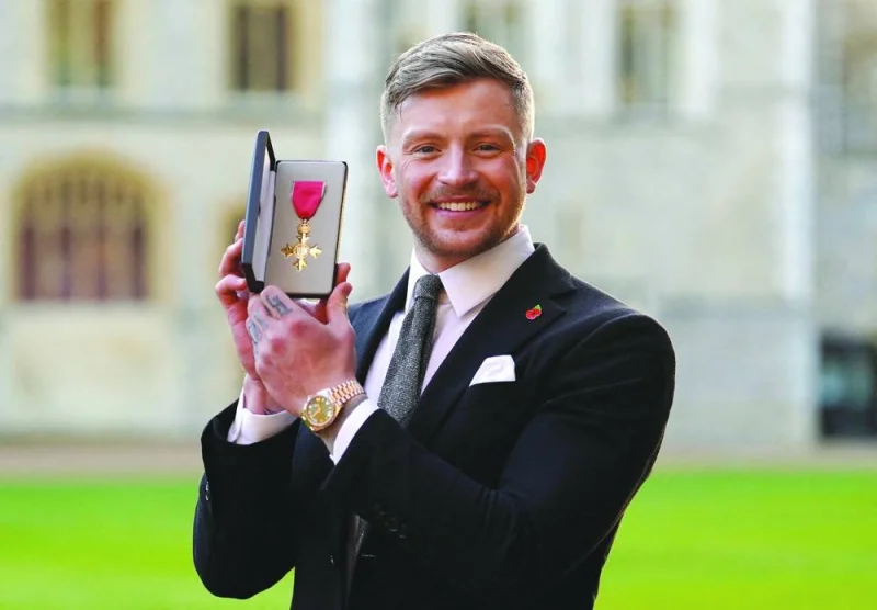 
Adam Peaty poses after being made an OBE (Officer of the Order of the British Empire) by the Princess Royal, during an investiture ceremony at Windsor Castle, Berkshire, Britain, on November 8, 2022. (Reuters) 