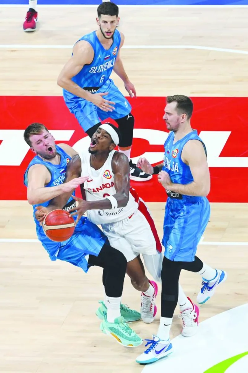 Canada’s Shai Gilgeous-Alexander (centre) holds the ball during  FIBA Basketball World Cup quarter-final against Slovenia in Manila on Wednesday. (AFP)