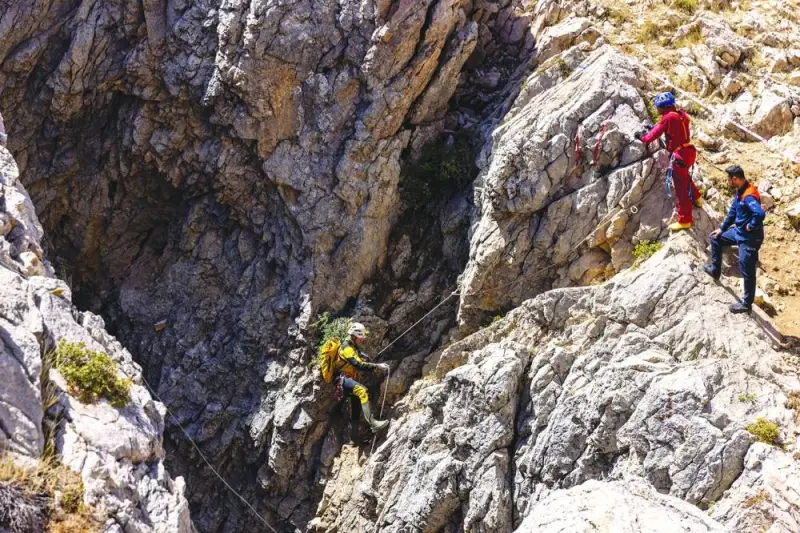 Rescuers descend to the entrance of Morca Cave as they take part in a rescue operation to reach US caver Mark Dickey who fell ill and became trapped some 1,000 meters underground, near Anamur in Mersin province, southern Turkey, on Friday.