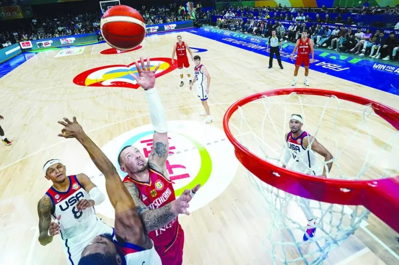 Franz Wagner (in red) of Germany competes for a rebound in the first half during the FIBA Basketball World Cup semi-final game against the United States at Mall of Asia Arena in Manila on Friday. Right: Serbia players celebrate after winning the FIBA World Cup semi-final against Canada at the same venue, on Friday. (AFP/Reuters)