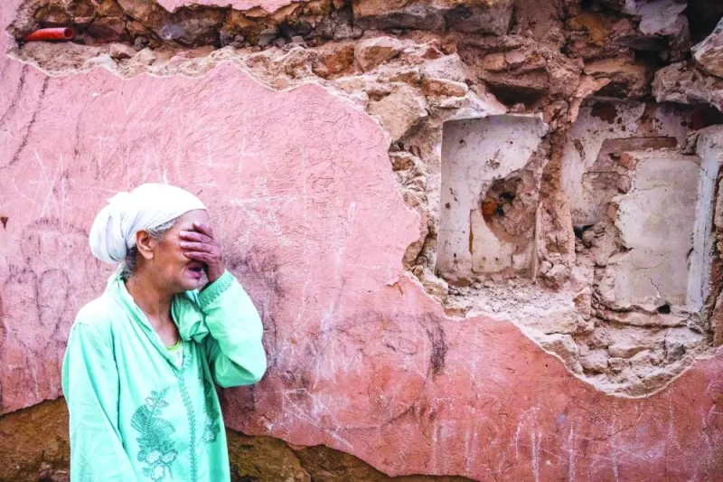 
A woman reacts standing in front of her earthquake-damaged house in the old city in Marrakesh yesterday. 