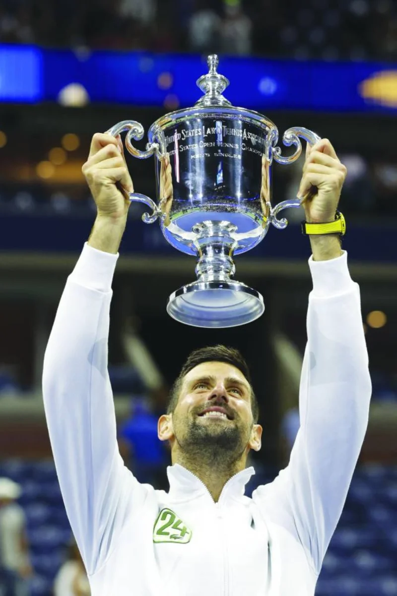 Serbia’s Novak Djokovic celebrates with the trophy after defeating Russia’s Daniil Medvedev in the US Open final in New York. (AFP)