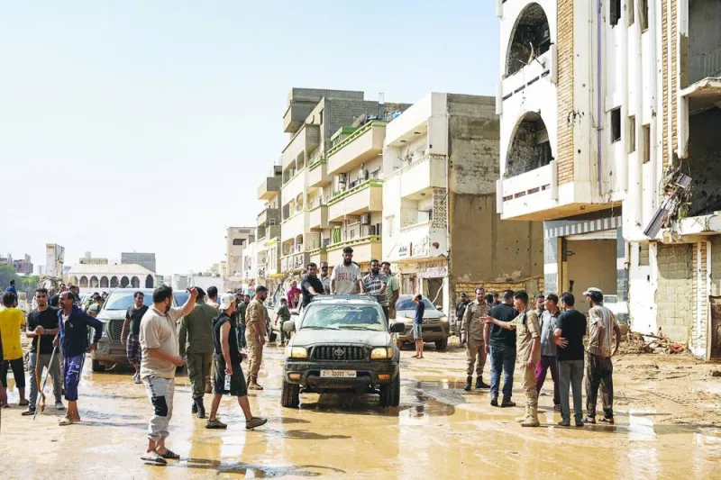 
This handout picture provided by the office of Libya’s Benghazi-based interim prime minister yesterday shows people inspecting damage in a flooded area in the eastern city of Benghazi in the wake of the Mediterranean storm “Daniel”. 