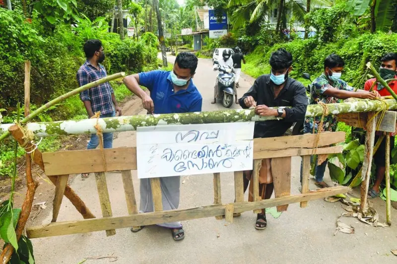 
Residents fix a sign reading “Nipah containment zone” on a barricade, put up to block a road after the authorities declared the area a containment zone, to prevent the spread of Nipah virus in Ayanchery village in Kozhikode district, Kerala, India, yesterday. 