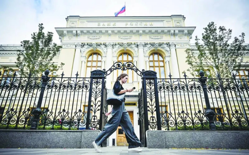 
A woman walks past the Russian central bank headquarters in downtown Moscow. The Bank of Russia raised its key interest rate by 100 basis points to 13% yesterday, jacking up the cost of borrowing for the third meeting in succession in response to a weak rouble and other persistent inflationary pressures. 
