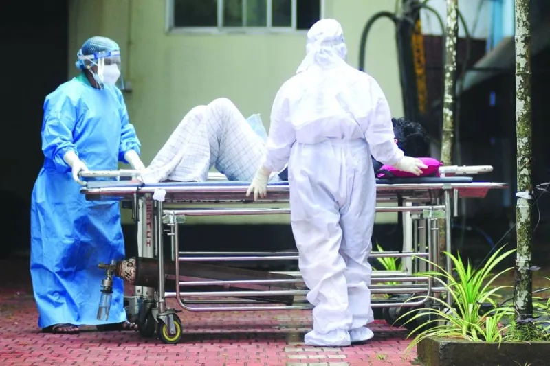 Health workers wearing protective gears shift a man with symptoms of Nipah virus to an isolation ward at a government hospital in Kozhikode.