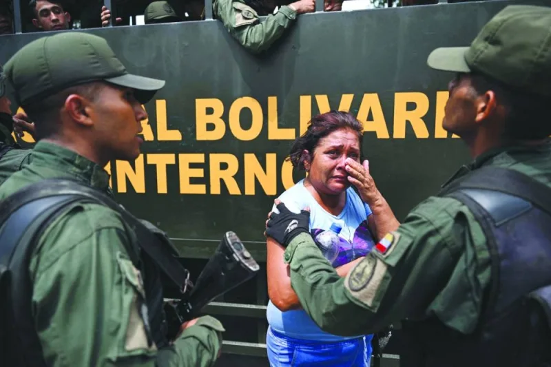 
A relative of an inmate is comforted by a member of the Bolivarian National Guard after authorities seized control of the Tocoron prison in Tocoron, Aragua State, yesterday. (AFP)  