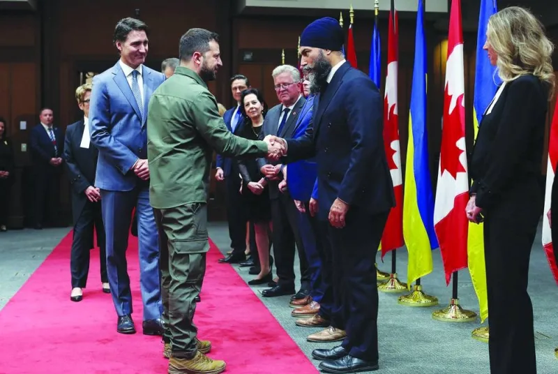 
Ukrainian President Volodymyr Zelensky, Prime Minister Justin Trudeau shake hands with New Democratic Party leader Jagmeet Singh during a ceremony on Parliament Hill in Ottawa. 