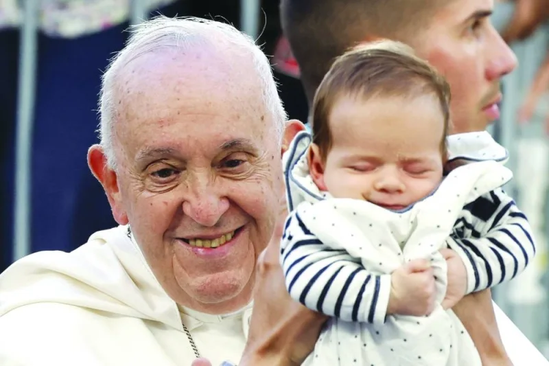 
A baby is held up to Pope Francis as he arrives at the Velodrome stadium in his popemobile for a mass in the southern port city of Marseille yesterday. He is the first Pope in 500 years to visit the city of Marseille. (AFP) 