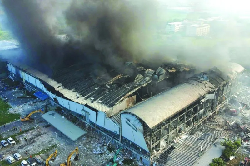 
An aerial view shows smoke billowing from a factory after a fire in Pingtung. 