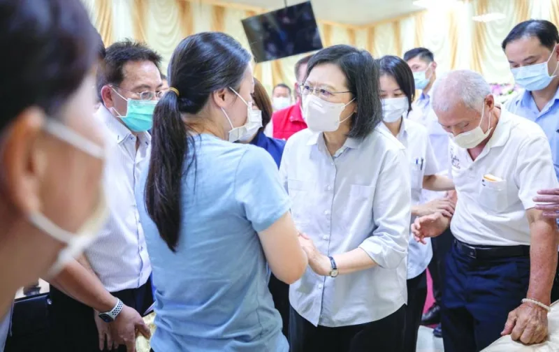 
Taiwan’s President Tsai Ing-wen speaks to a woman while visiting a funeral home to pay respect to the firefighters who died during a fire at a factory in Pingtung, Taiwan. 