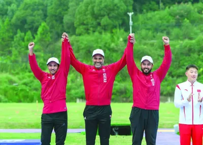Qatar’s Nasser al-Attiyah (centre), Masoud al-Athba (left) and Rashid al-Athba celebrate after winning skeet team silver medal at the Hangzhou Asian Games on Wednesday.