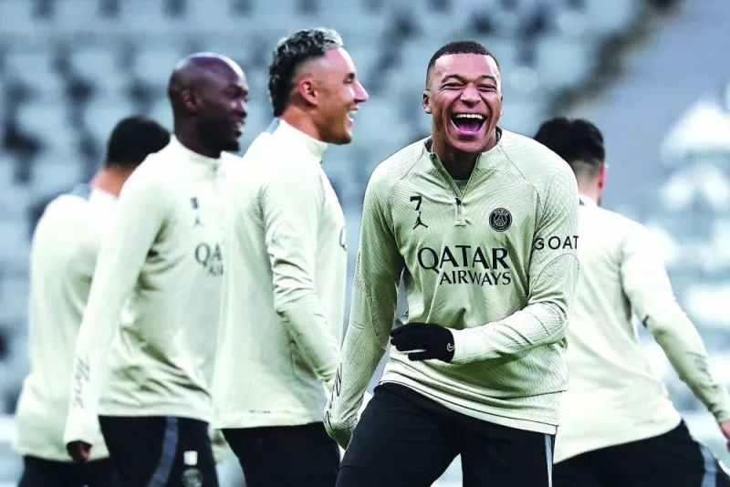 PSG’s forward Kylian Mbappe (right) jokes during a team training session on Tuesday, on the eve of their UEFA Champions League Group F match against Newcastle United. (AFP)