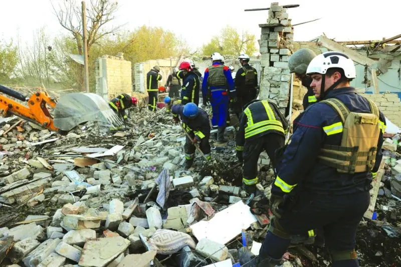 
Rescuers work amongst the rubble of a destroyed shop and cafe after a Russian strike in the village of Groza. 