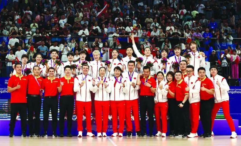 China’s basketball squad pose with their gold medals at the Hangzhou Olympic Sports Centre on Thursday. (Reuters)
