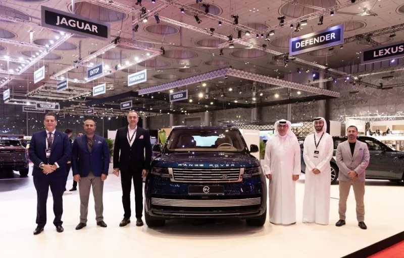 Alfardan Premier Motors Co top officials along with the latest models of Jaguar Land Rover vehicles at the GIMS.
