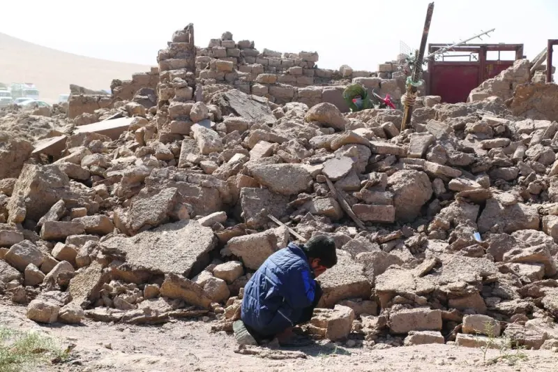
A boy cries near debris in the aftermath of an earthquake in the district of Zendeh Jan, Afghanistan. 