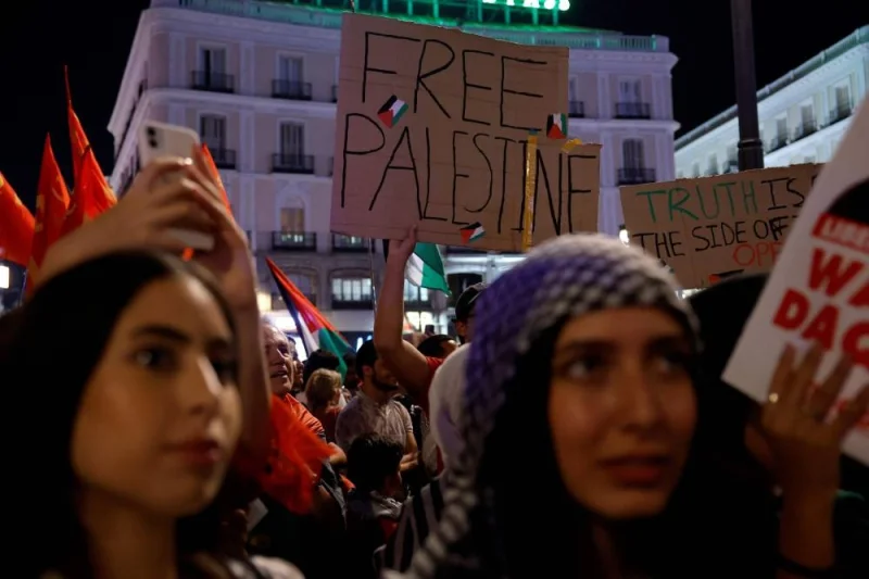 Protestors hold banners during a rally in support of Palestinians in Madrid Monday. AFP