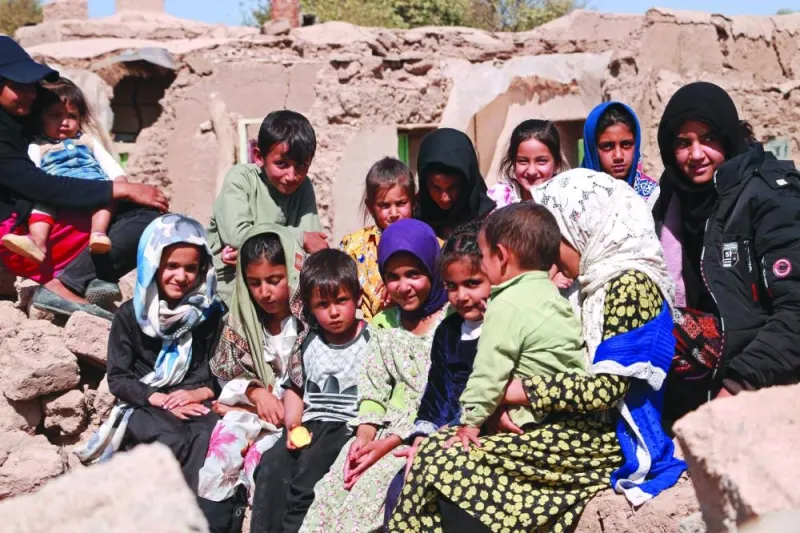 Children sit near damaged houses after earthquake in Wardakha village of Zendeh Jan district of Afghanistan’s Herat province.