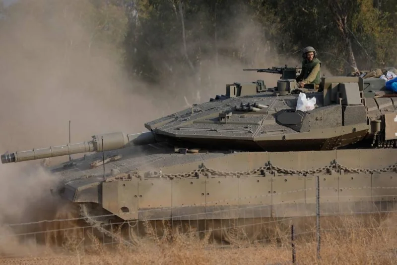 Israeli Merkava tanks advance to a position in the upper Galilee in northern Israel near the border with Lebanon Wednesday. AFP