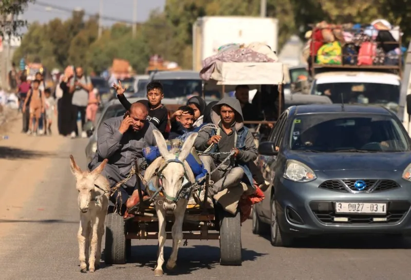  Riding a donkey drawn cart as family along with hundreds of other Palestinian carrying their belongings flee following the Israeli army&#039;s warning to leave their homes and move south before an expected ground offensive, in Gaza City  Friday. AFP