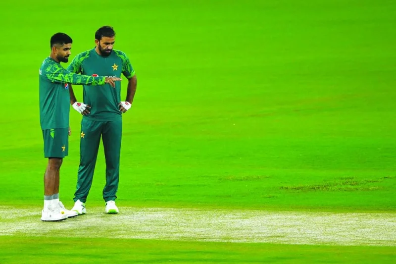 Pakistan’s captain Babar Azam (left) and Iftikhar Ahmed view the pitch during a practice session on Friday. (AFP)