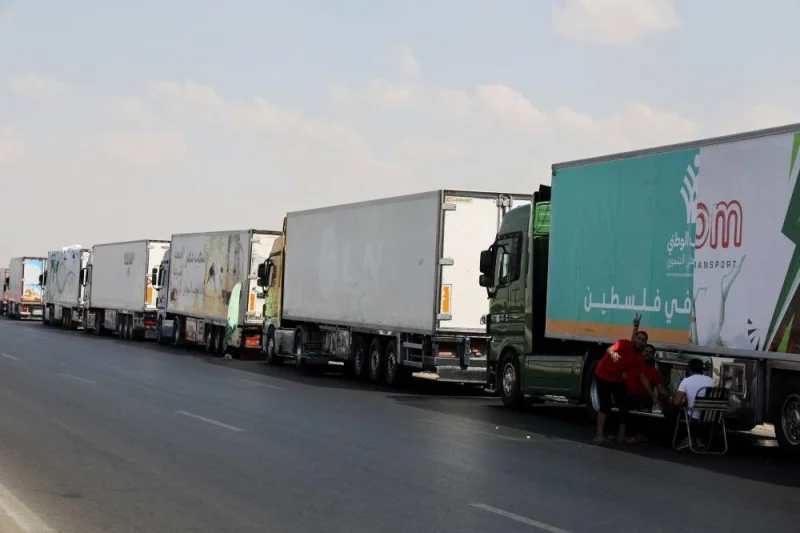 Trucks carrying humanitarian aid to Palestinians, wait on the desert road (Cairo - Ismailia) on their way to the Rafah border crossing to enter Gaza, amid the ongoing conflict between Israel and the Palestinian Islamist group Hamas, in Cairo, Egypt, Saturday. REUTERS