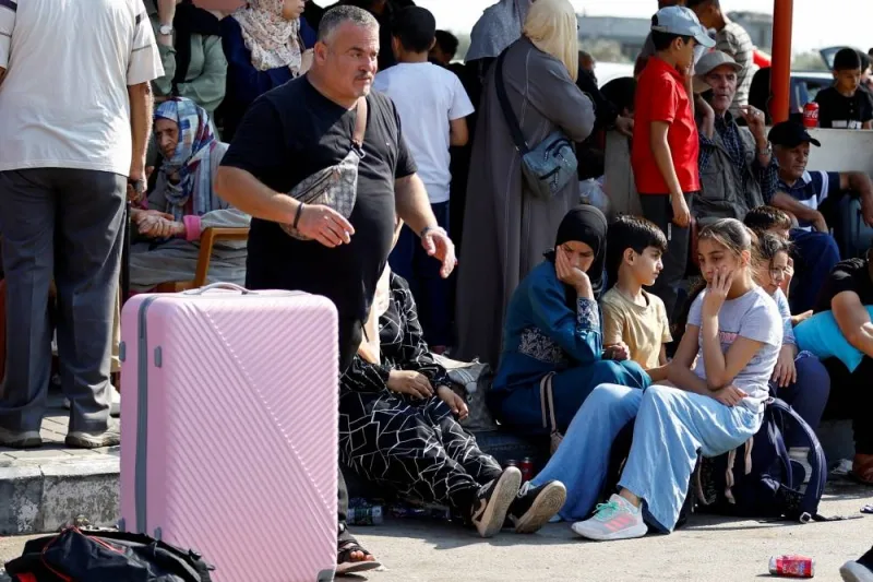 Palestinians with dual citizenship wait outside Rafah border crossing with Egypt in the hope of getting permission to leave Gaza, amid the ongoing Israeli-Palestinian conflict, in Rafah in the southern Gaza Strip Saturday. REUTERS