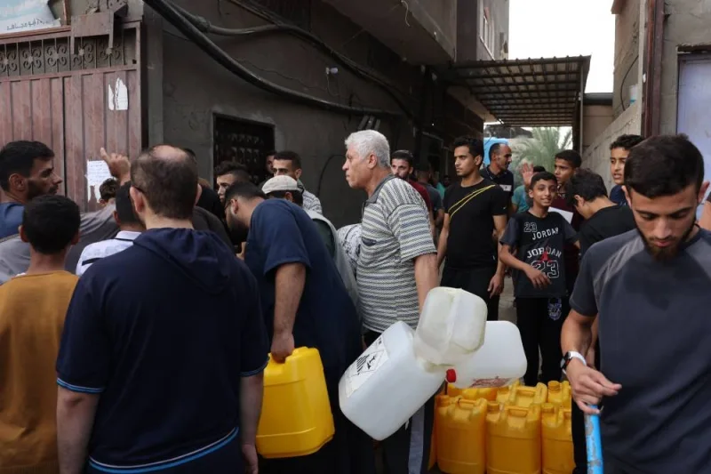 Palestinians queue to refill on water in Rafah refugee camp in the southern of Gaza Strip, on Saturday. AFP