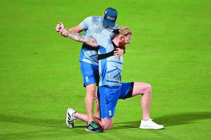 England’s Ben Stokes (right) stretches during a practice session on Saturday, on the eve of the ICC World Cup one-day international match against Afghanistan in New Delhi. (AFP)