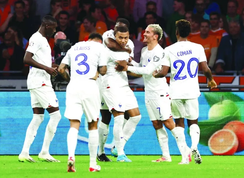 
France’s Kylian Mbappe (centre) celebrates with teammates after scoring against the Netherlands during the Euro 2024 qualifier in Amsterdam on Friday. (Reuters) 