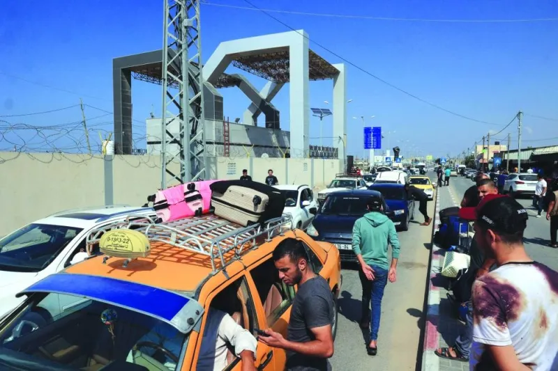 
Palestinians with foreign passports arrive at the Rafah gate hoping to cross into Egypt as Israel’s attacks on the Gaza Strip continued yesterday. 