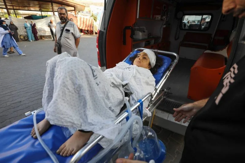 Medics transport an injured Palestinian girl into Al-Shifa hospital in Gaza City following Israeli bombardment on Sunday. AFP