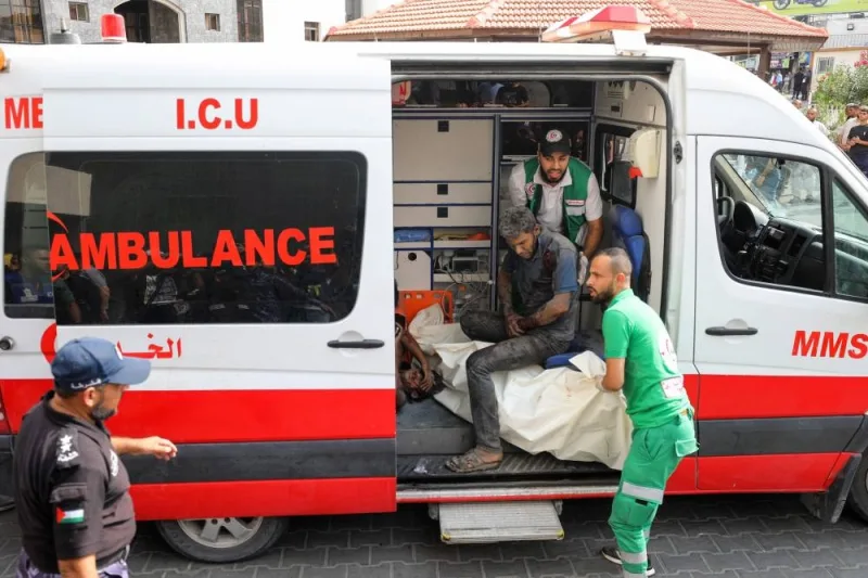 Medics transport injured Palestinians into Al-Shifa hospital in Gaza City following Israeli bombardment on Sunday. AFP
