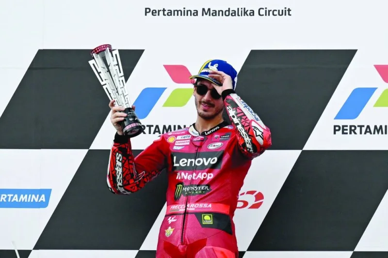 
First-placed Ducati Lenovo Team’s Italian rider Francesco Bagnaia celebrates with the trophy during the podium ceremony of the Indonesian Grand Prix MotoGP at the Mandalika International Circuit in Kuta Mandalika, 
Central Lombok, Indonesia, yesterday. (AFP) 