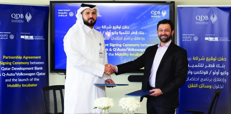 Dr Hamad Salem Mejegheer, executive director of QDB’s Advisory and Incubation Services, and Ahmed Shariefi, managing director of Q-Auto, shaking hands after the agreement signing ceremony.