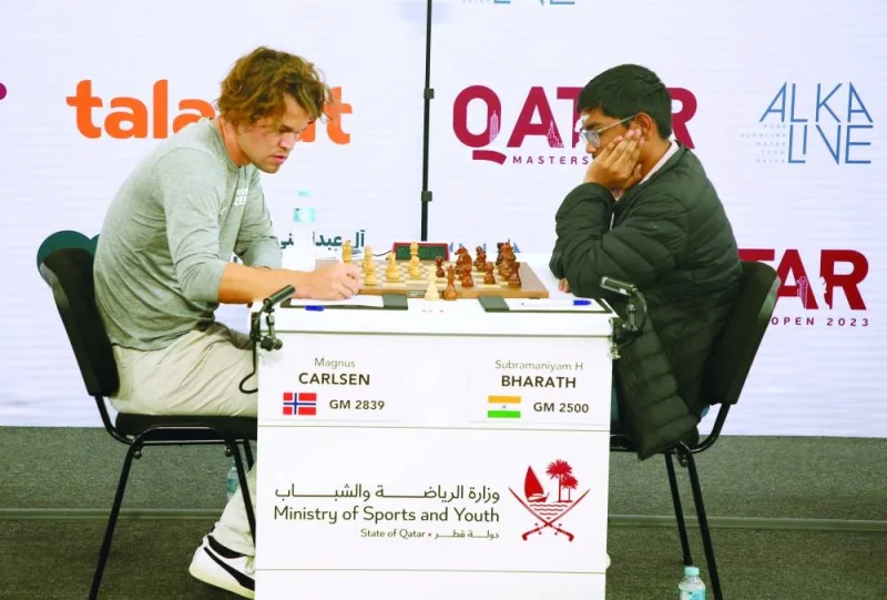 World champion Magnus Carlsen of Norway and Subramaniyam Bharath of India pondering over their moves during fifth round of Qatar Masters at the Lusail Multipurpose Hall in Doha yesterday.