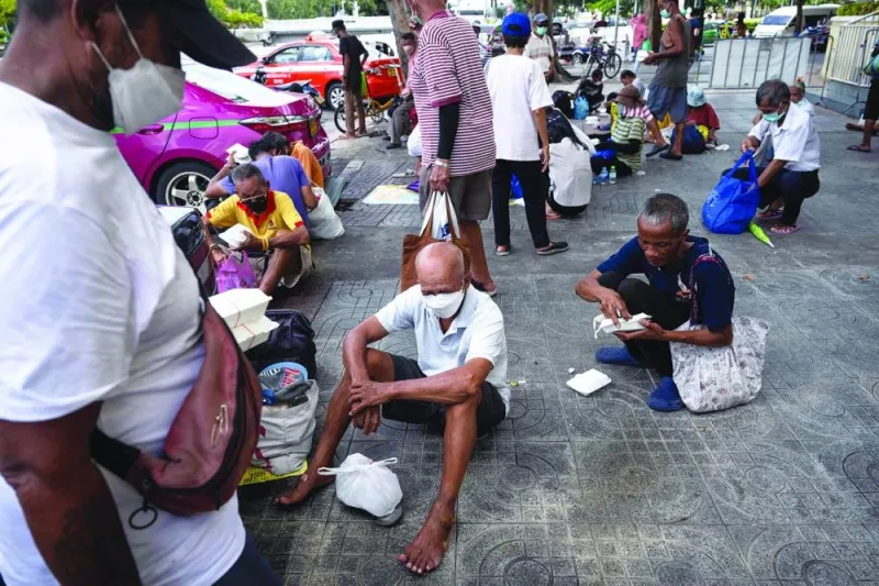 
Senior citizens queuing up for daily food donations from Bangkok Community Help Foundation, near the Grand Palace in Bangkok. 