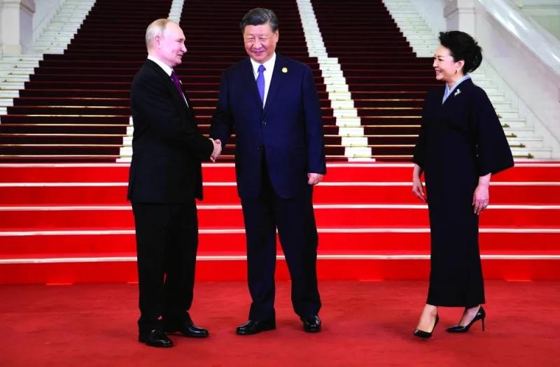 
Russia’s President Vladimir Putin and China’s President Xi Jinping shake hands during a welcoming ceremony at the Third Belt and Road Forum in Beijing yesterday. Also seen is  the Chinese president’s wife, Peng Liyuan. 