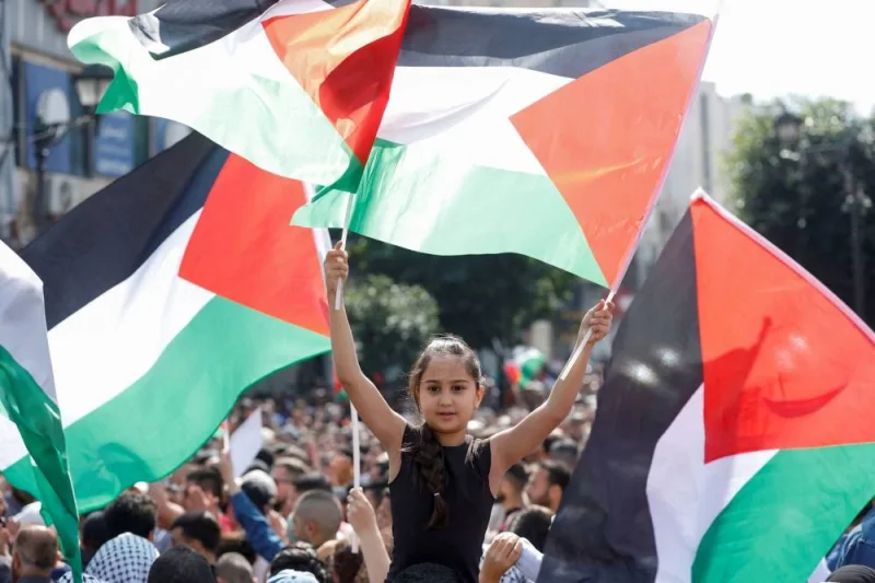A girl holds Palestinian flags as Palestinians take part in a protest in support of the people in Gaza, after hundreds of Palestinians were killed in a blast at Al-Ahli hospital in Gaza that Israeli and Palestinian officials blamed on each other, in Ramallah in the Israeli-occupied West Bank Wednesday. REUTERS