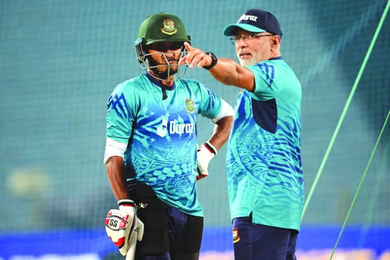 Bangladesh coach Chandika Hathurusingha (right) talks to a player during a practice session in Pune on Wednesday.