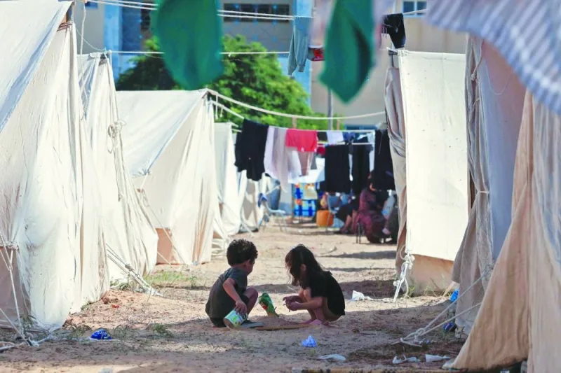 Children play among tents set up for Palestinians seeking refuge on the grounds of a United Nations Relief and Works Agency for Palestine Refugees (UNRWA) centre in Khan Yunis, in the southern Gaza Strip.