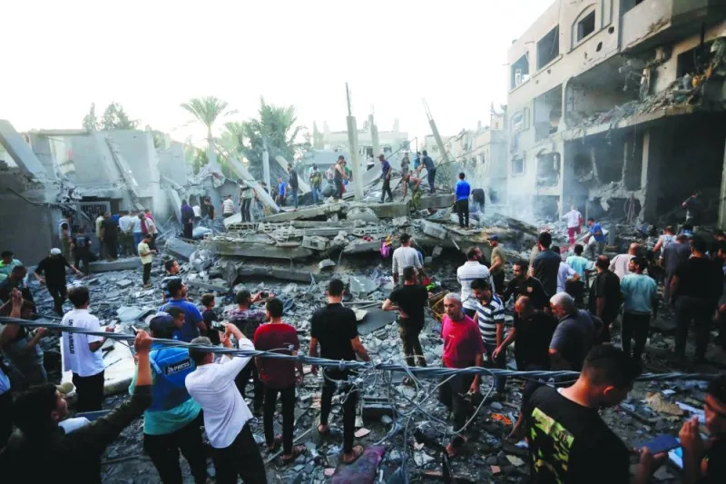 
Rescuers are seen following an Israeli strike on the town of Deir Al-Balah in the central Gaza Strip. 