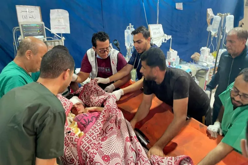 Trauma surgeons cover the body of a pregnant woman whose baby was rescued after an emergency Caesarean section operation, and who died after Israeli bombardment, at the Kuwaiti hospital in Rafah in the southern Gaza Strip on Saturday. AFP