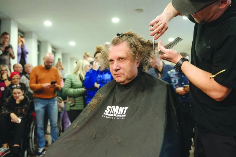 
Jacek Karnowski, former mayor of Sopot who has now been elected to the Polish Parliament, has his hair cut, fulfilling a promise that he would do so when the country’s ruling nationalist Law and Justice (PiS) party were voted out of office, in Sopot, Poland, on October 18. 