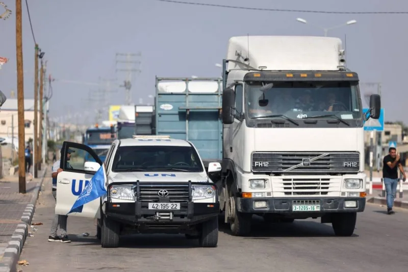 Trucks carrying aid enter the Gaza Strip through the Rafah crossing with Egypt on Sunday. AFP