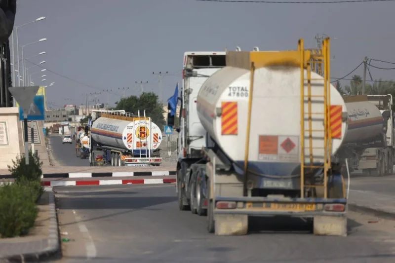Trucks carrying fuel enter the Gaza Strip through the Rafah crossing with Egypt on Sunday. AFP