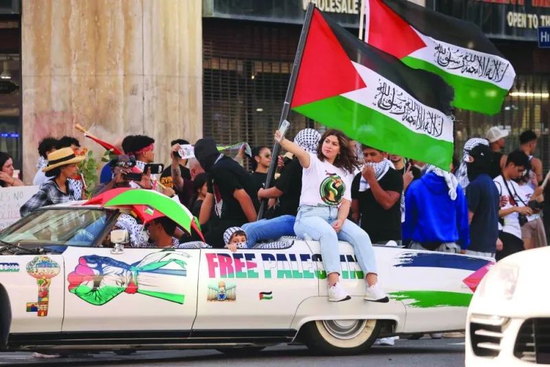 
People wave Palestinian flags as they rally in support of Palestinians in Los Angeles, California. 
